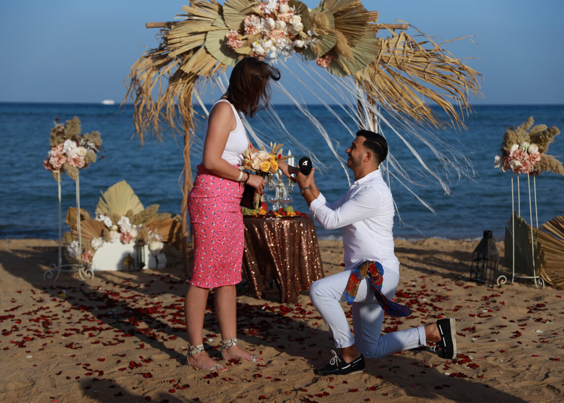a man proposing to a woman on a beach