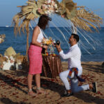 a man proposing to a woman on a beach